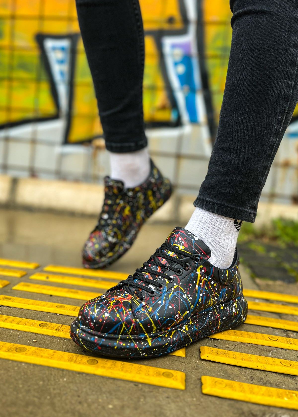 Stardust Edge hand-painted custom sneaker by Apollo Moda, worn on yellow tactile paving