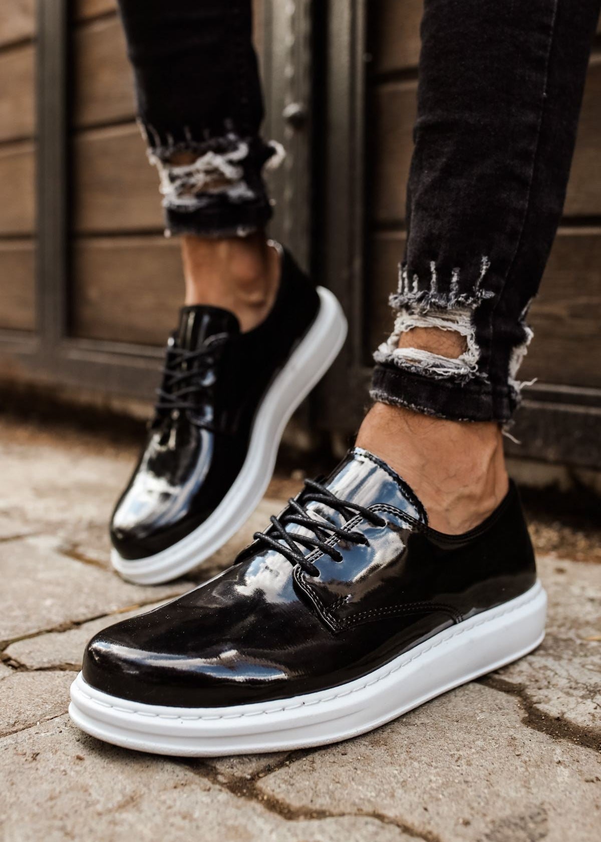 Lazio Patent Prestige patent dress shoe in black by Apollo Moda, worn on stone pavement