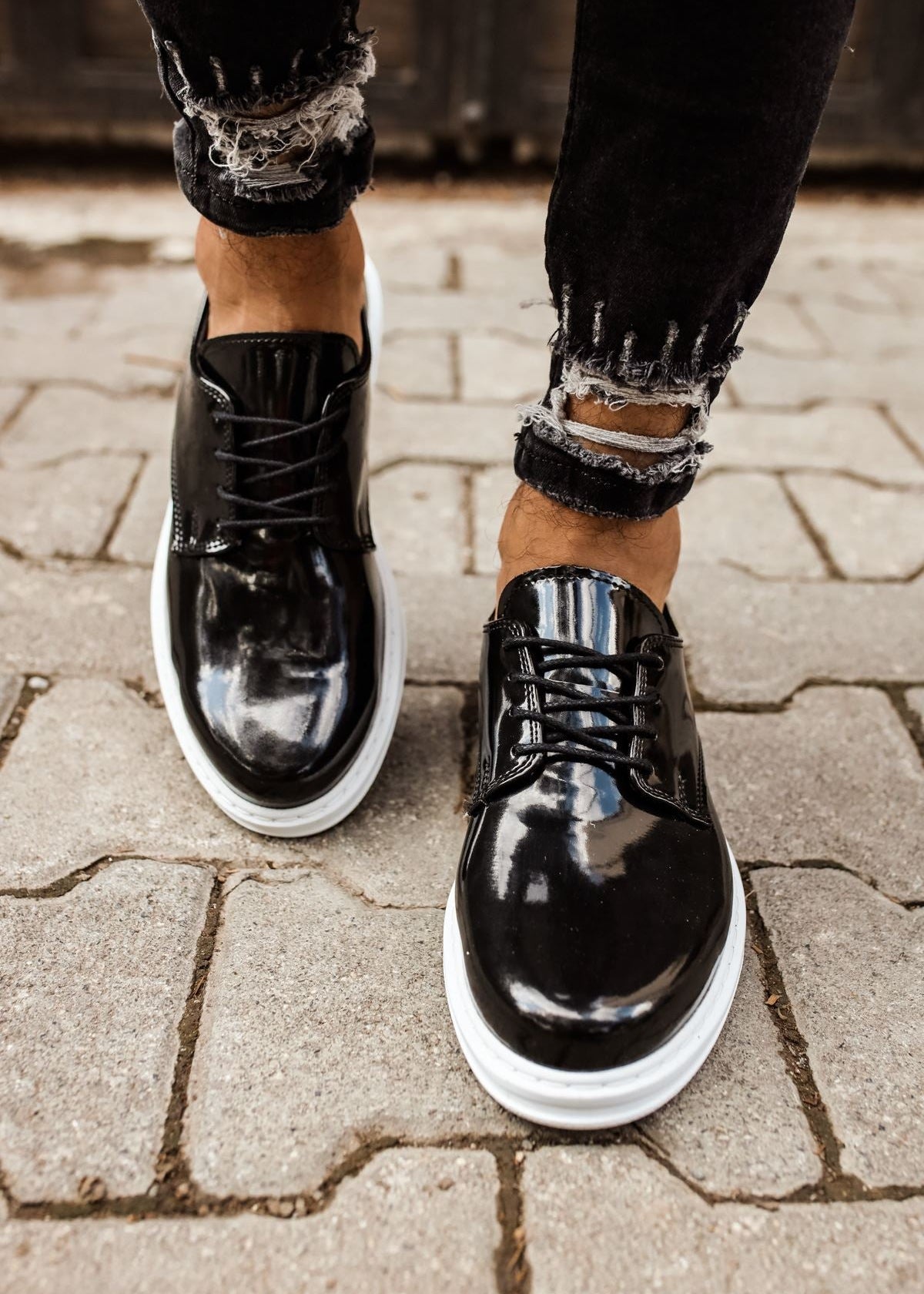 Lazio Patent Prestige patent dress shoe in black by Apollo Moda, worn on a paved surface