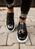Lazio Patent Prestige patent dress shoe in black by Apollo Moda, worn on a paved surface